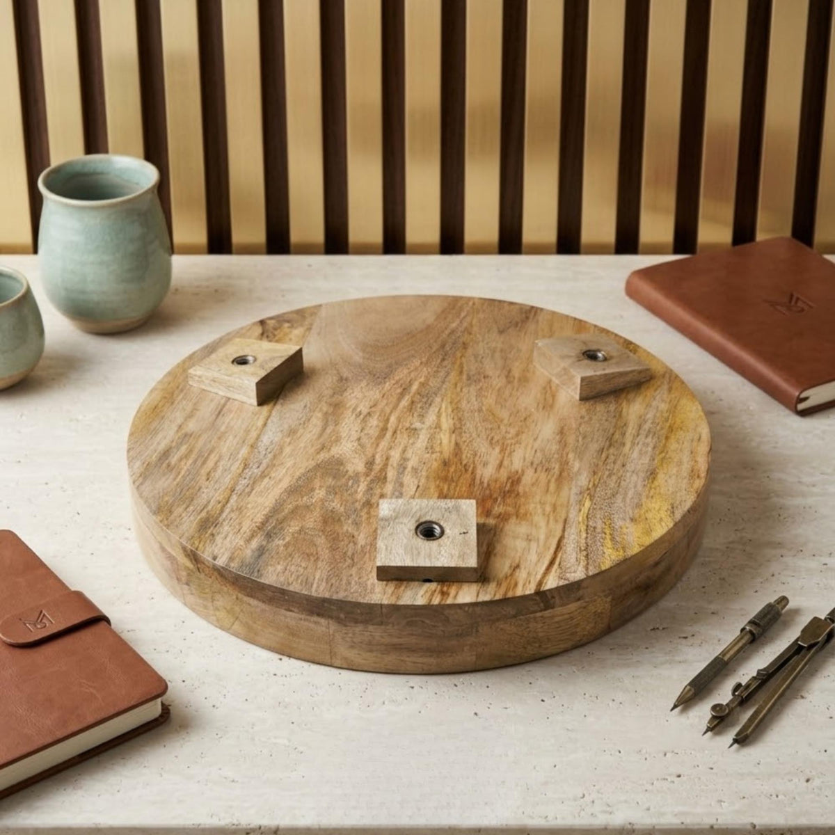 Underside of a round wooden tabletop showing the leg attachment blocks.