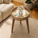 Hummingbird Glass-Top Mango Wood Side Table, shown beside a sofa in a styled room.