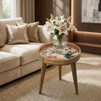 Hummingbird Floral Mango Wood Side Stand, shown beside a sofa in a styled room.