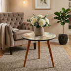 Ivory Wave Round Side Table, Glossy Lacquer, shown beside a sofa in a styled room.