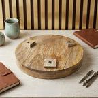 Underside of a round wooden tabletop showing the leg attachment blocks.