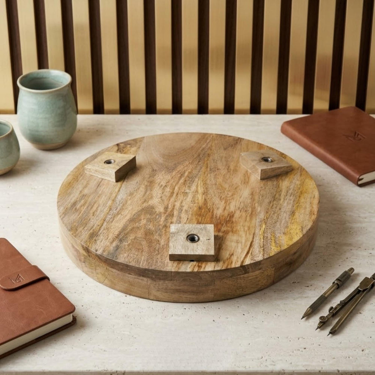 Underside of a round wooden tabletop showing the leg attachment blocks.