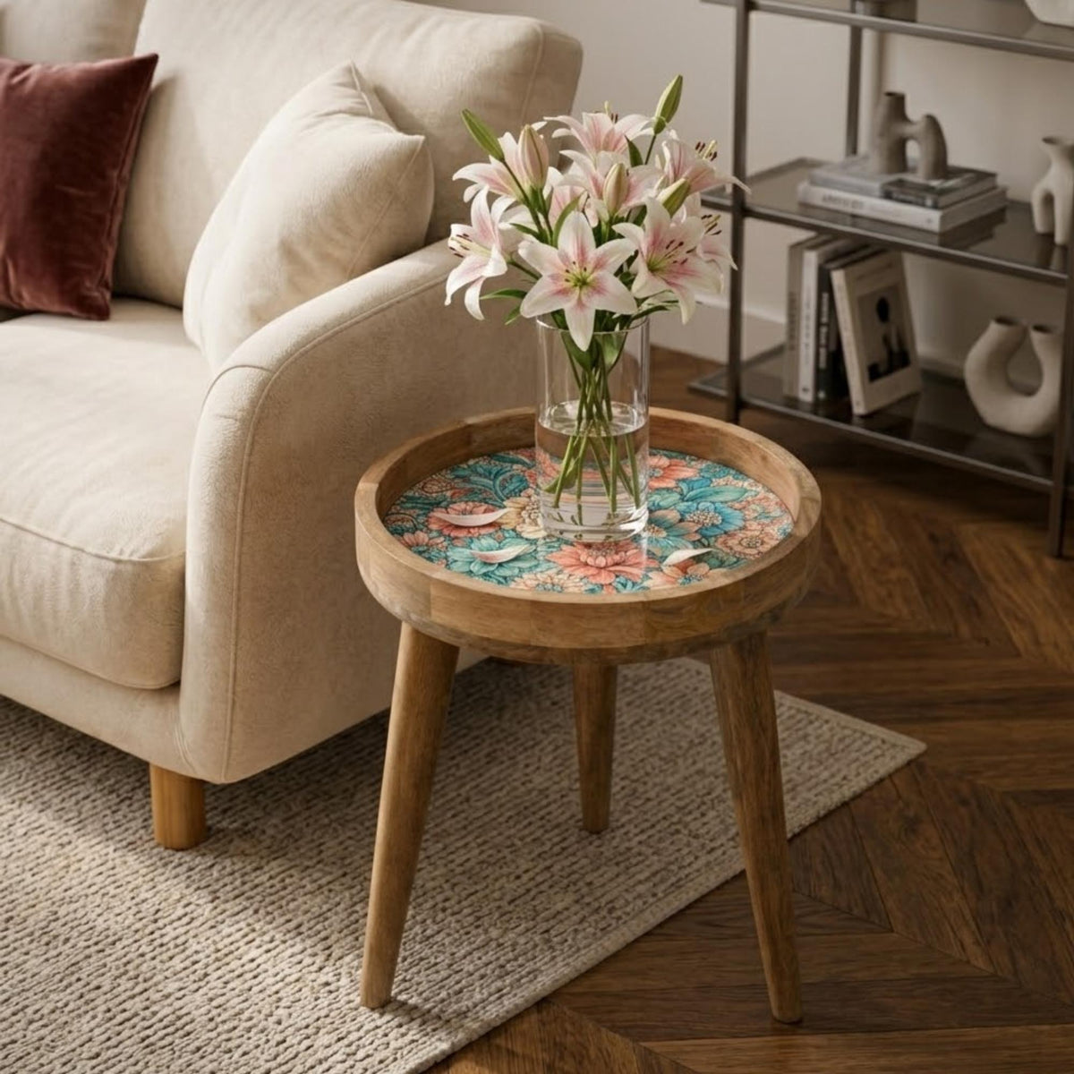 Teal & Pink Floral Glass-Top Mango Wood Side Table, shown beside a sofa in a styled room.