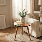Japandi Botanical Print Round Side Table, shown in a styled room near a window.