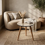 Abstract Wave Round Side Table, Glossy Lacquer, shown beside a sofa in a styled room.