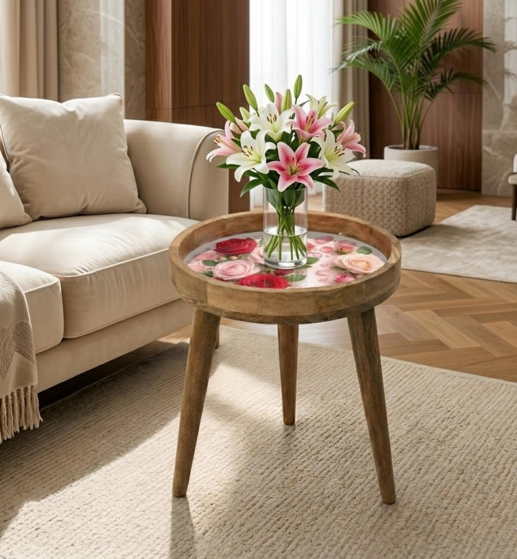 Rose Print Glass-Top Mango Wood Side Table, shown beside a sofa in a styled room.