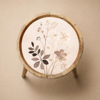 Top view of the neutral botanical mango wood side table, showing the printed design.