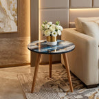 Blue Geode Print Round Side Table, shown beside a sofa in a styled room.